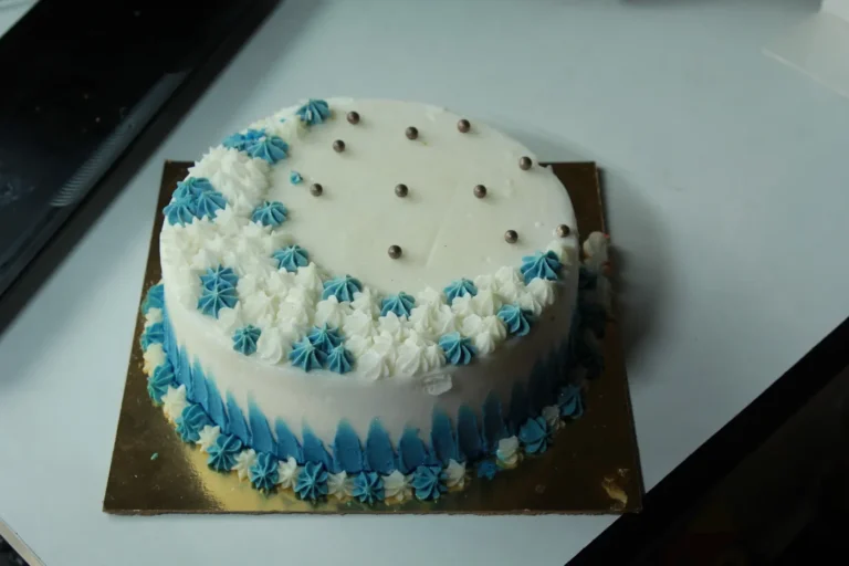 Birthday cake with blue cream rosettes