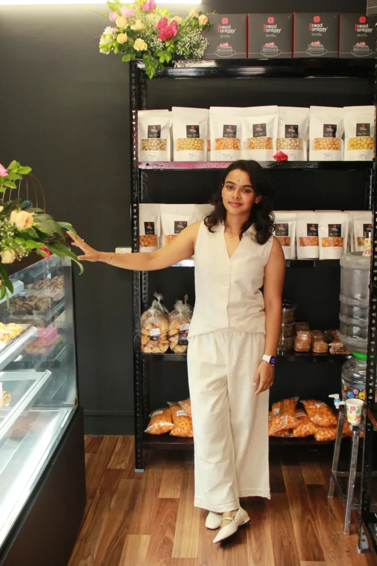 Founder of Bread Fantasy in the store beside the product shelves